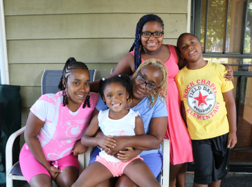 Ms. Goody with her family in their Westview home a block.