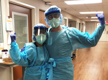 CVICU Nurses flex muscles in full PPE
